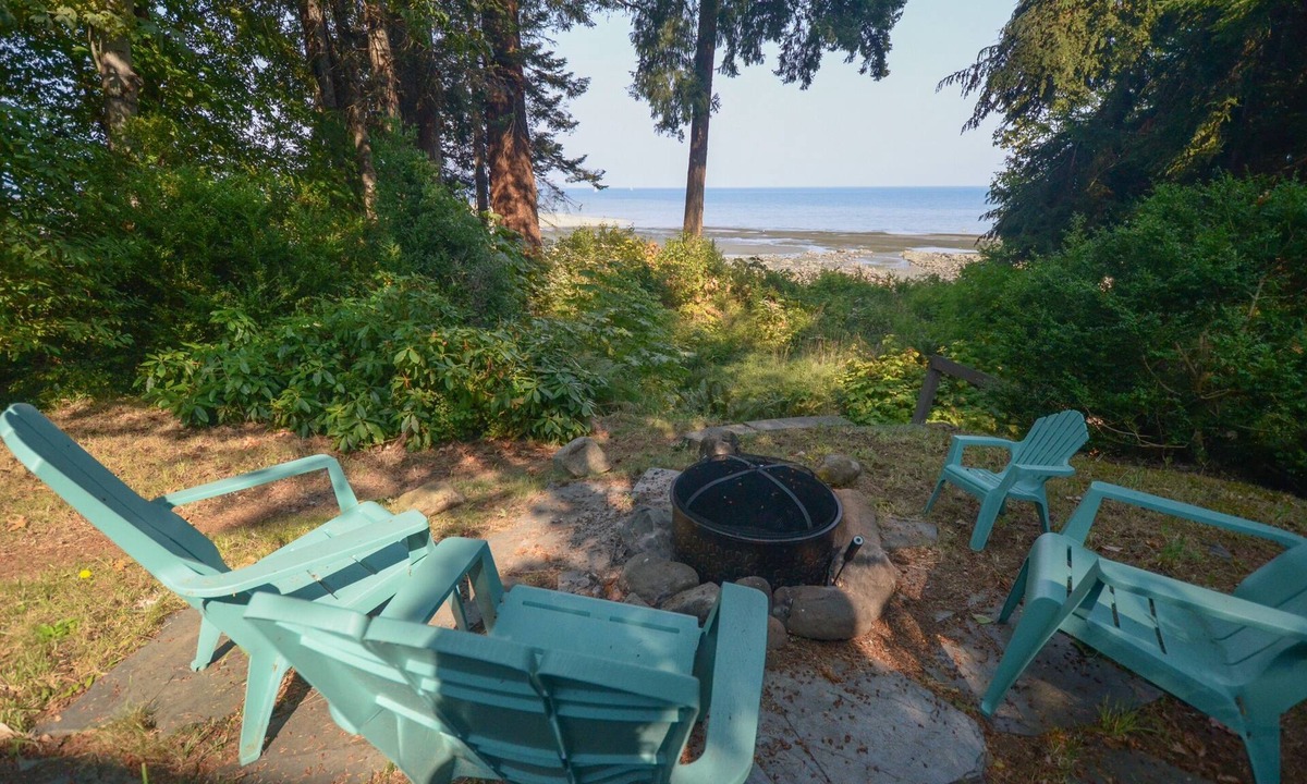 Courtenay House | Beachfront Cottage: Brick Fireplace + Ocean Deck