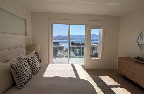 Central Okanagan House | 5 minutes to downtown Kelowna! Roof top patio with views of Okanagan Lake.