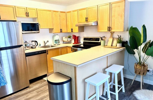 Panorama Condo | Boho theme, Ground floor patio with green space and creek view. 2 min to gondola