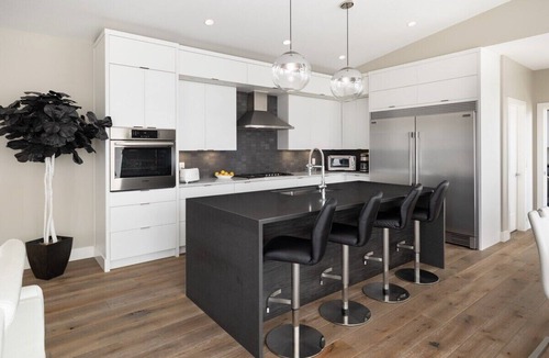 Southwest Mission House | Hilltop Upper Mission retreat in Kelowna: private pool, hot tub & sweeping Okanagan Lake views. Features 3 bedrooms, designer kitchen, gym space, ping pong, and two levels of outdoor living. Short drive to beaches, wineries, and downtown.