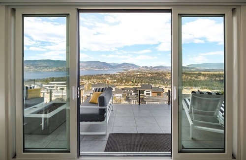 Southwest Mission House | Hilltop Upper Mission retreat in Kelowna: private pool, hot tub & sweeping Okanagan Lake views. Features 3 bedrooms, designer kitchen, gym space, ping pong, and two levels of outdoor living. Short drive to beaches, wineries, and downtown.
