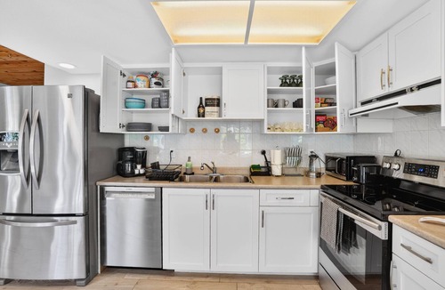Upper Lonsdale House | Large fully renovated 2-bedroom ground-level suite with a fenced backyard