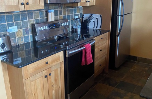 Golden House | Mountain views from hot tub in this 3br/2bath ski/bike in home at Kicking Horse