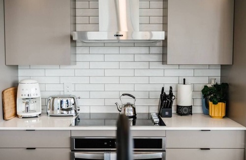Downtown Kelowna Condo | Stay at The Retro Revival, a designer condo on the 16th floor of Brooklyn on Bernard. Enjoy panoramic lake/mountain views, curated retro decor, a balcony with BBQ, rooftop terrace, and walkable access to Kelowna’s dining and waterfront.