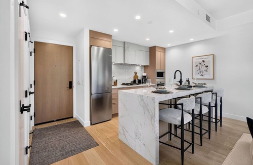 South Pandosy Condo | Unwind in this elegant Aqua Waterfront Village retreat featuring a king bedroom, sofa bed, spa-inspired bathroom, gourmet kitchen, and private patio with BBQ. Steps from Okanagan Lake, beaches, cafés, and resort-style amenities.