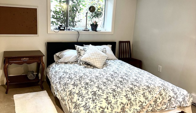 Cozy Garden level suite with heated floors. 1 block off “The Drive”.