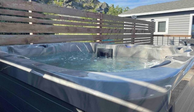 Escape to The Blue Bird – a cozy 2-bedroom cottage with hot tub and partial ocean views! Just 5 mins from Carbonear & 15 mins to Salmon Cove Sands.