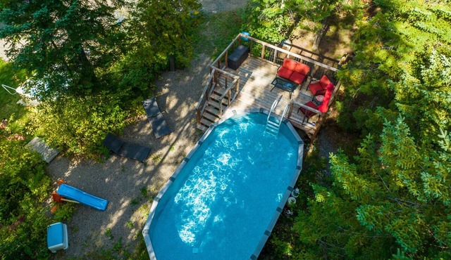 Nestled in the heart of nature, La Romane combines contemporary design, warmth, and comfort — featuring a private spa year-round, billiard room, and a heated pool in summer.