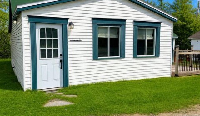 Relax at The Bonavista Branch House - Port Rexton, a cozy 2BR retreat near Skerwink Trail and Trailway. Once home to railway engineers and conductors, this updated cottage offers firepit evenings, local dining, Port Rexton Brewing, and Nfld charm.