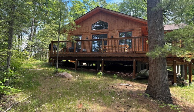 Timber cottage with large deck overlooking the water. Boat access only, no road.