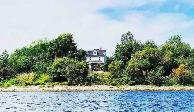 Waterfront homestead on 4 landscaped acres.